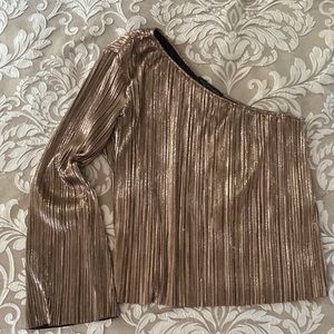 Woman’s one shoulder rose gold metallic top